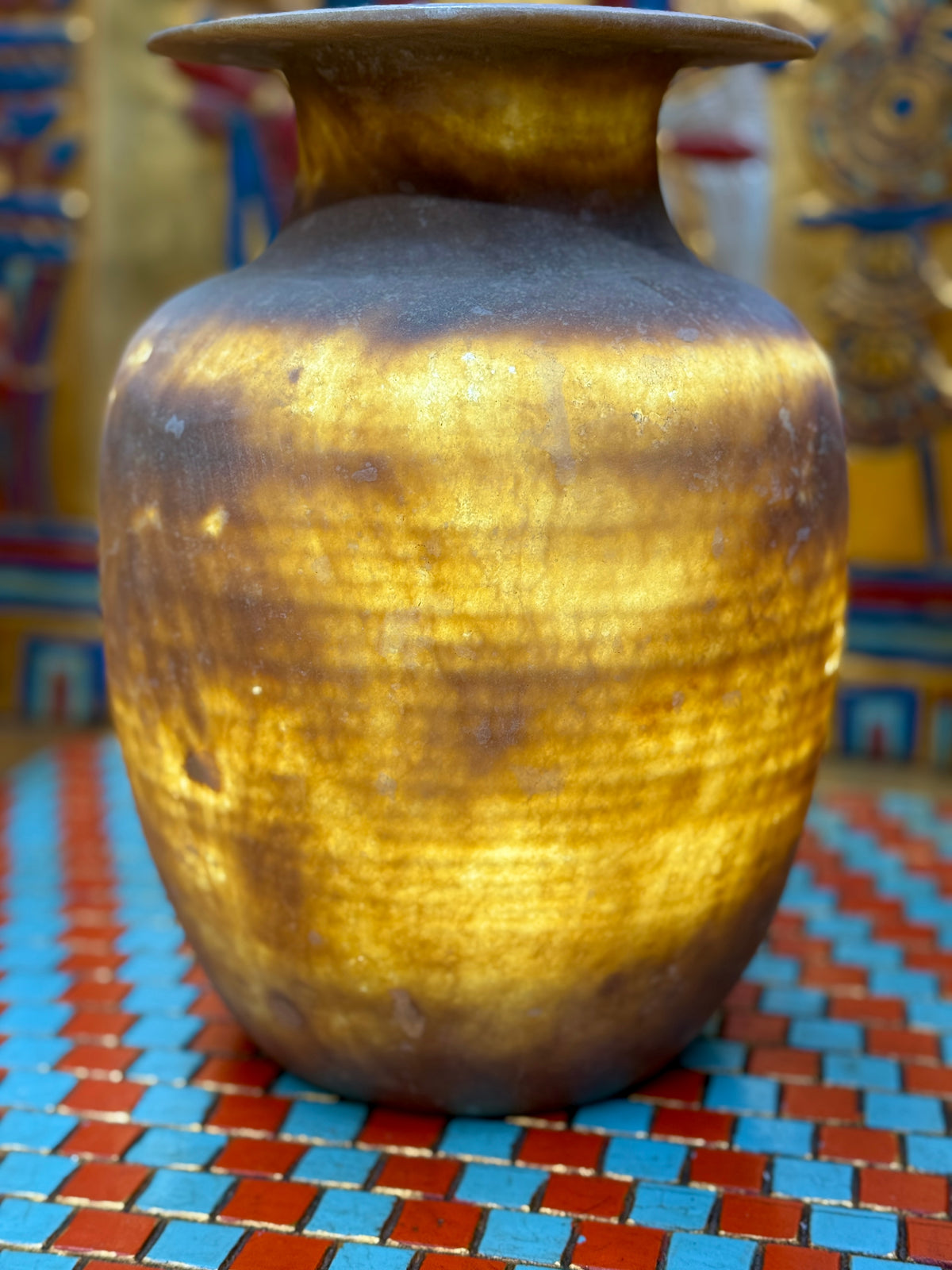 Smoky grey-brown alabaster vase with a tapering body, rounded shoulders and a broad flared rim — illuminated view showing golden bands.