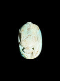 Top view of Egyptian scarab SC-114, showing pale blue and cream tones.