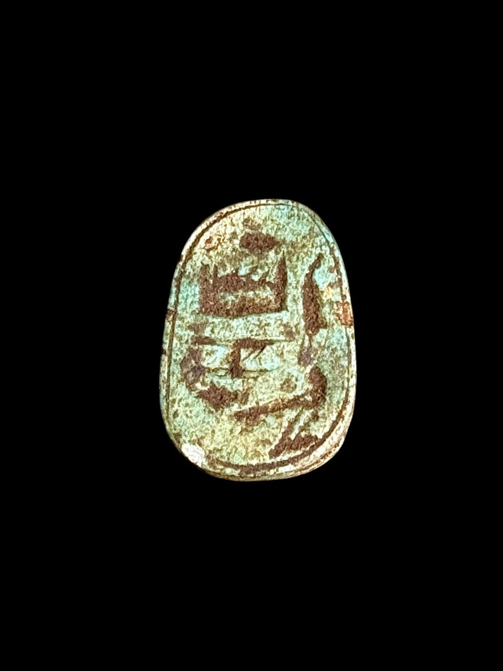 Underside of Egyptian scarab SC-110, showing blue-green underside with darker incised markings.