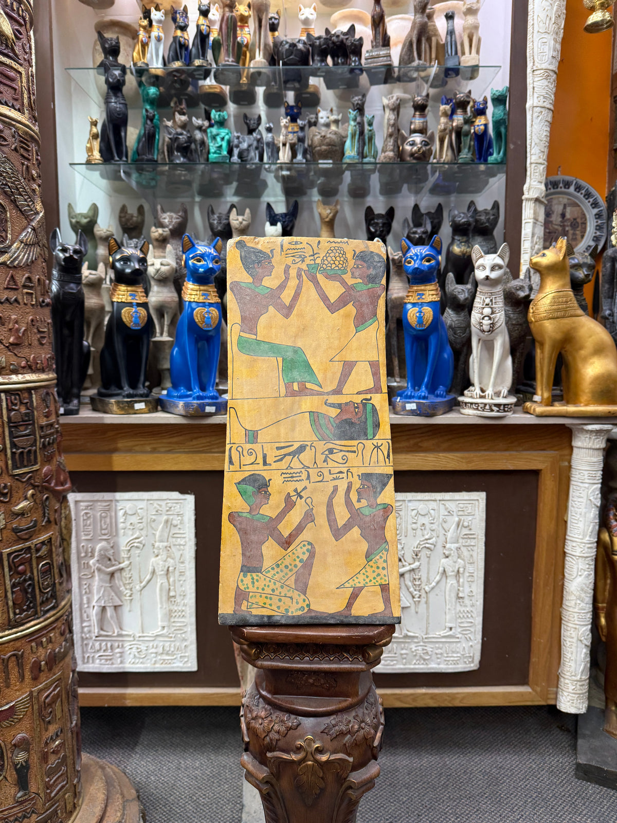 Full front view of the 17.5 by 8 inch Book of the Dead wood plaque, displayed upright in the shop.