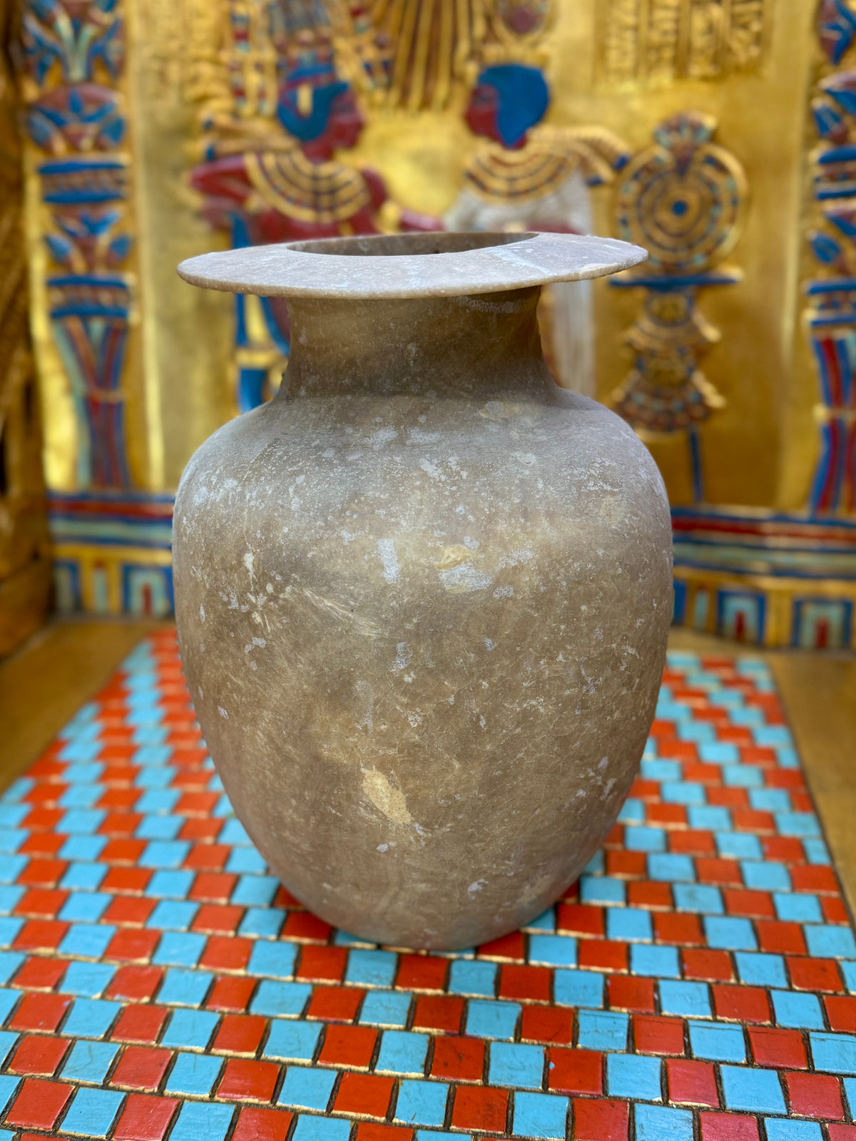 Smoky grey-brown alabaster vase with a tapering body, rounded shoulders and a broad flared rim — unlit full view.