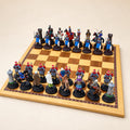 Crusaders vs. Arabs pewter chess pieces arranged on a display chessboard, with dark red and black bases. Board not included.