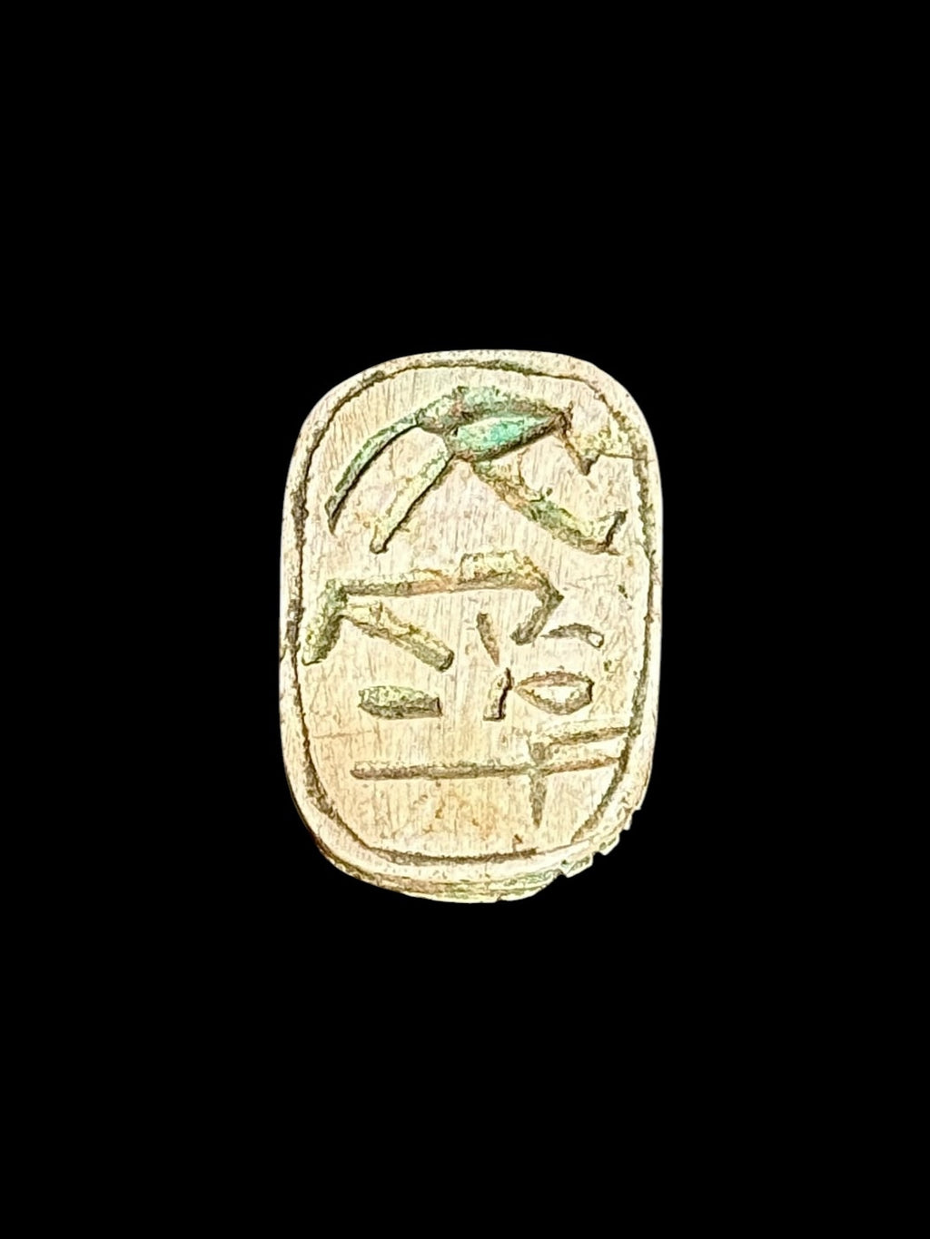 Underside of Egyptian scarab SC-119, showing pale green underside with darker incised motifs.