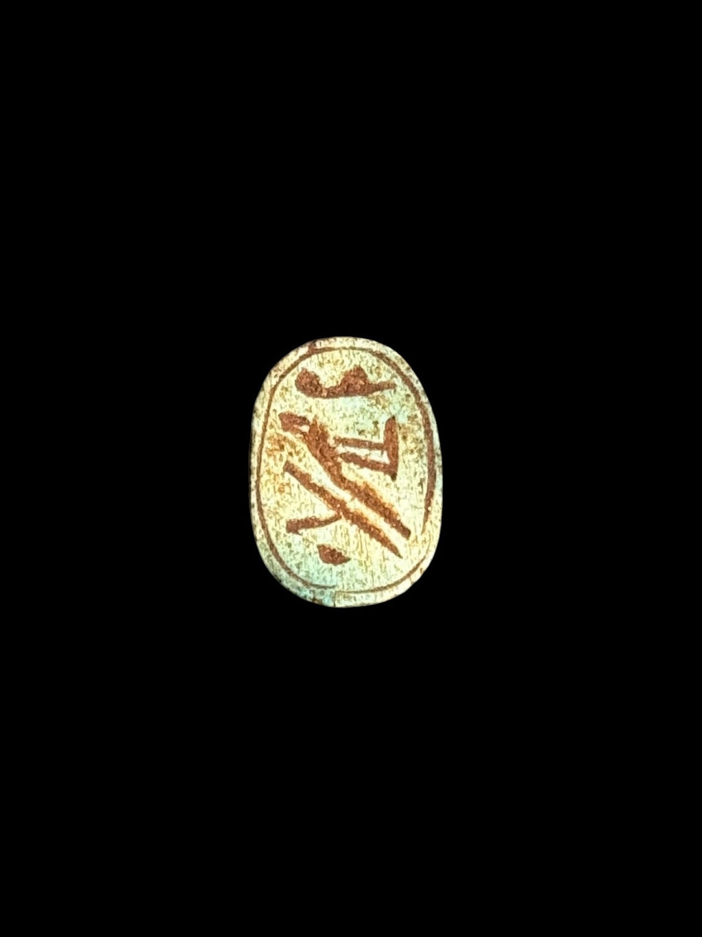 Underside of Egyptian scarab SC-072, showing pale green underside with contrasting brown markings.