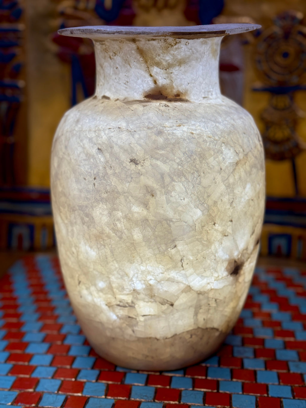 Tall pale alabaster vase with branching brown veins, an upright neck and flared rim — additional view 1.