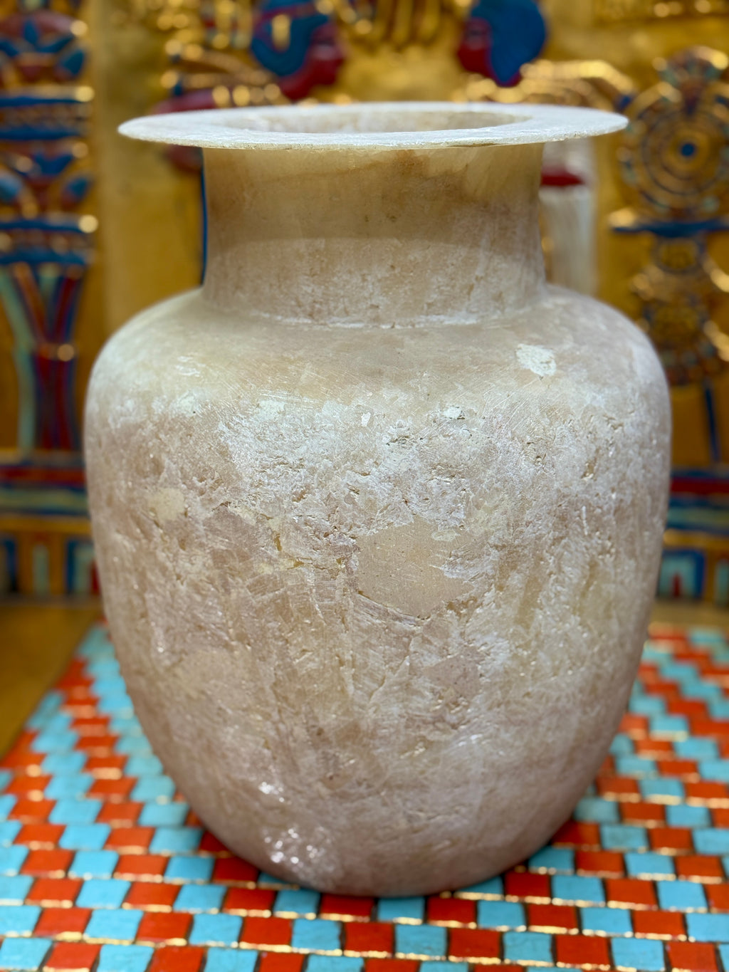 Large cream and sandy taupe alabaster vase with broad shoulders, a straight neck and flared rim — unlit full view.