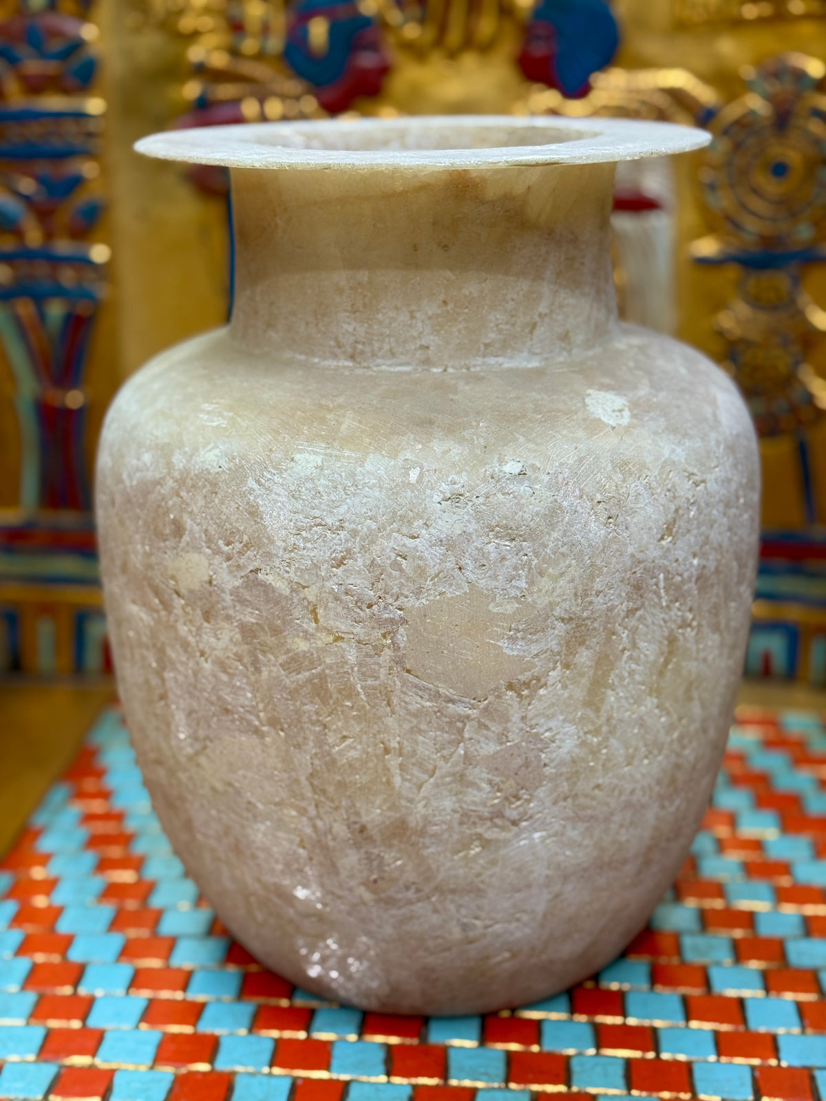 Large cream and sandy taupe alabaster vase with broad shoulders, a straight neck and flared rim — unlit full view.