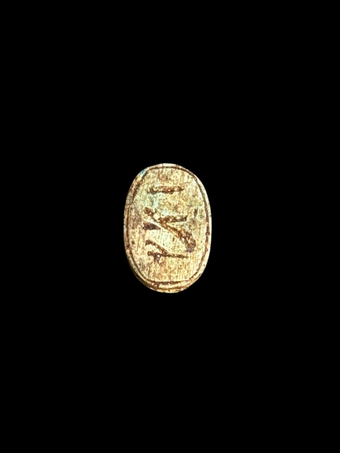 Underside of Egyptian scarab SC-069, showing pale underside with darker markings and muted green accents.