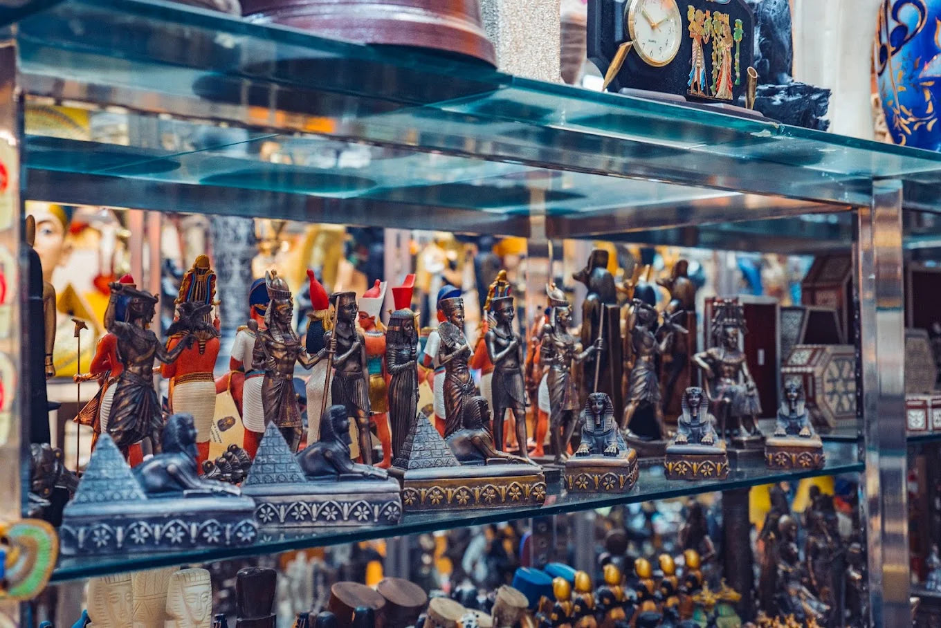 Egyptian deity statues and sphinx figures displayed on glass shelves inside Son of the Pharaoh.