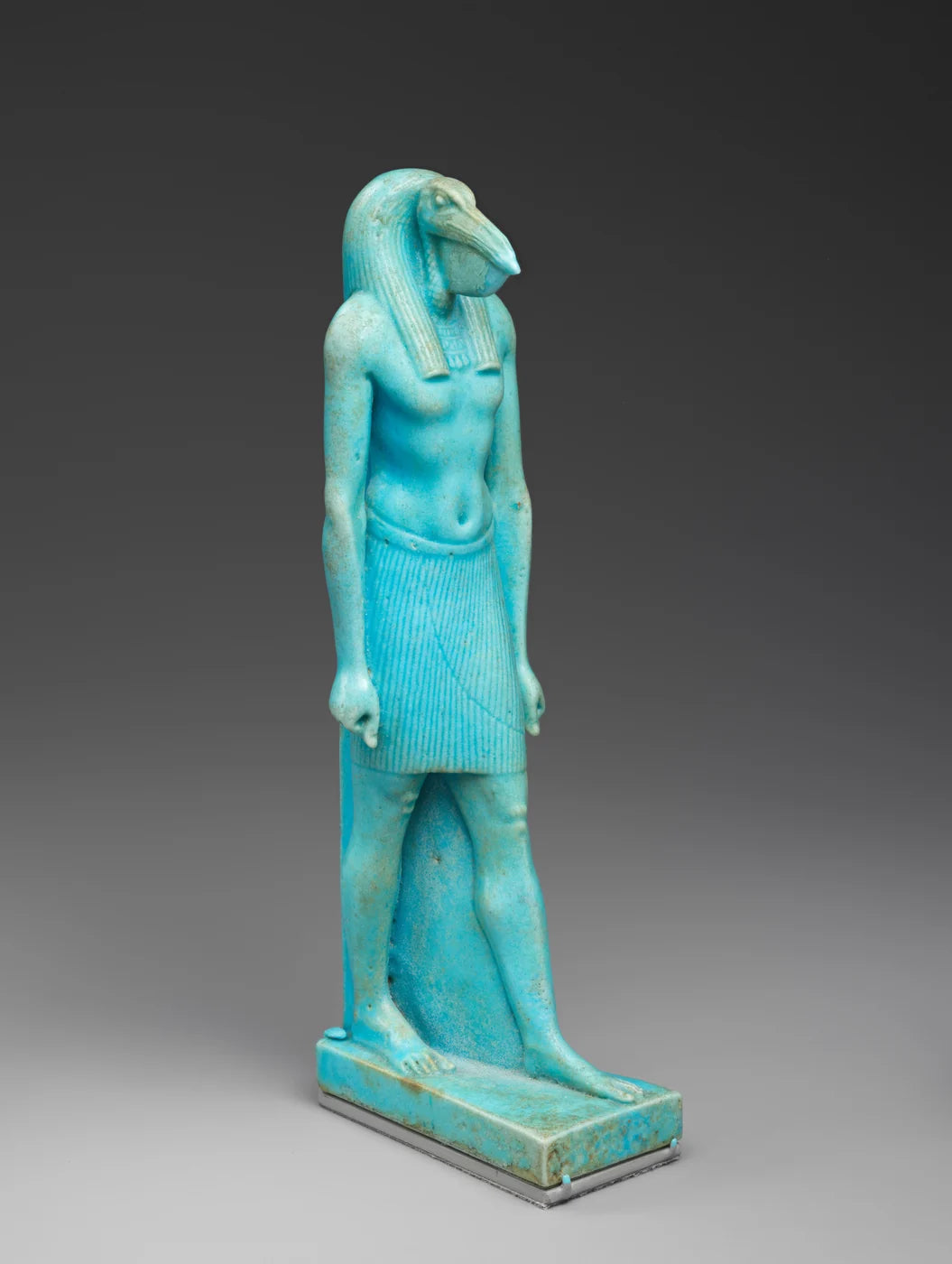 Striding Thoth; faience.